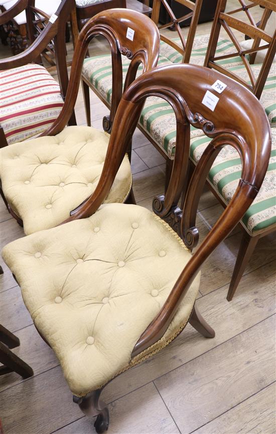 A pair of Victorian mahogany dining chairs, with yellow buttoned upholstered seats